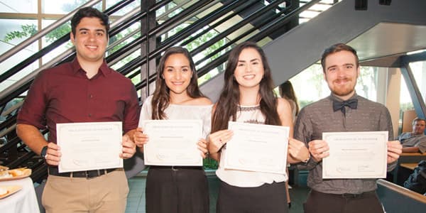Four students holding their awards