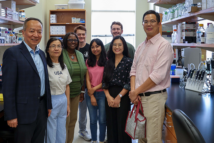 group of people standing in medical research lab