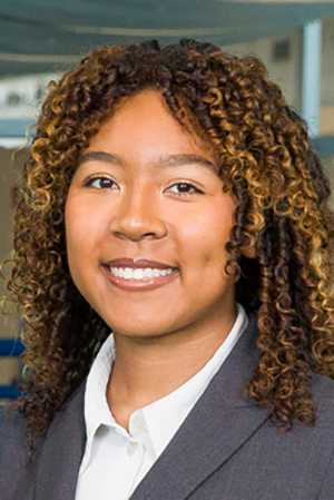 photo of woman with curly hair in suit