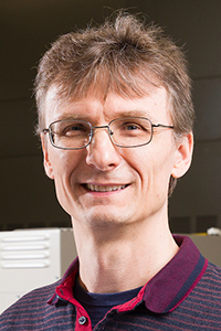 photo of man in glasses and striped polo shirt