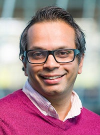 photo of many in glasses with pink shirt and sweater