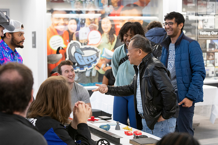 group of people laughing in front of table