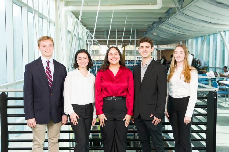 The five members of engineering senior design team 223 stand together on the third floor breezeway at the FAMU-FSU College of Engineering.