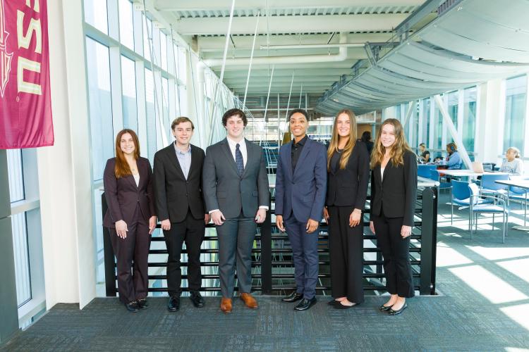 The six members of engineering senior design team 105 stand together on the third floor breezeway at the FAMU-FSU College of Engineering.