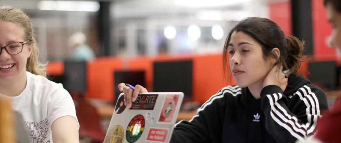 Three smiling students during a study session
