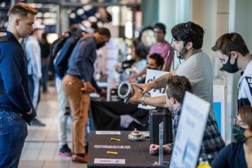 Engineering students talking about a prototype