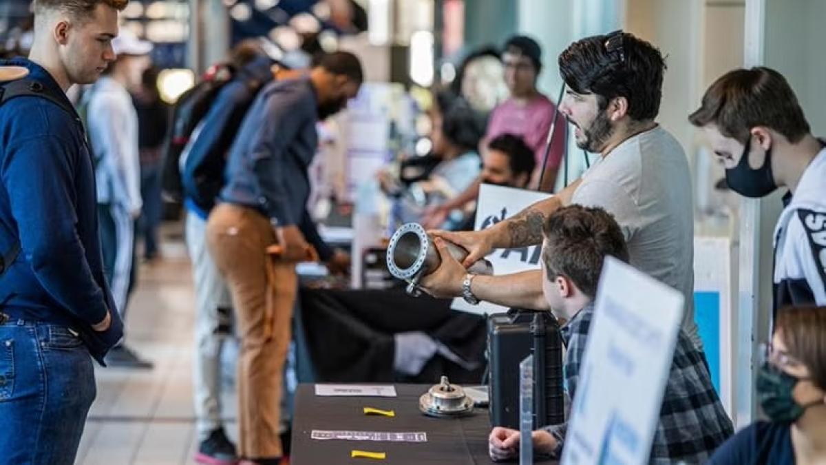 Engineering students talking about a prototype