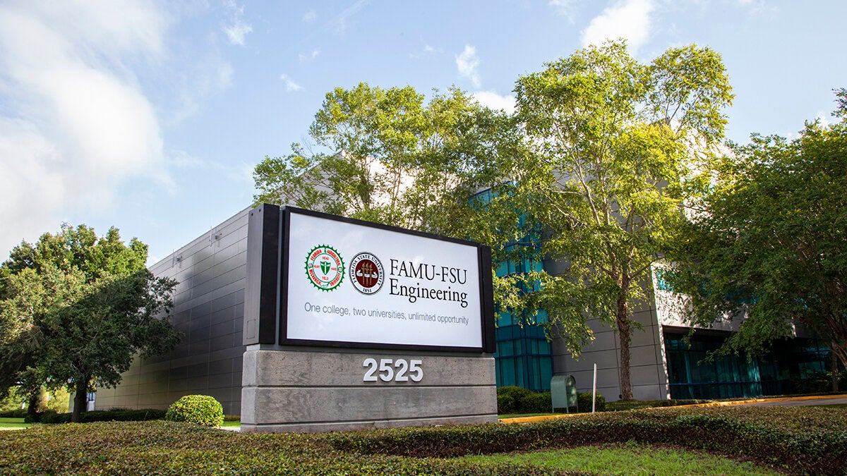 photo of the famu-fsu engineering sign against trees and building and blue sky