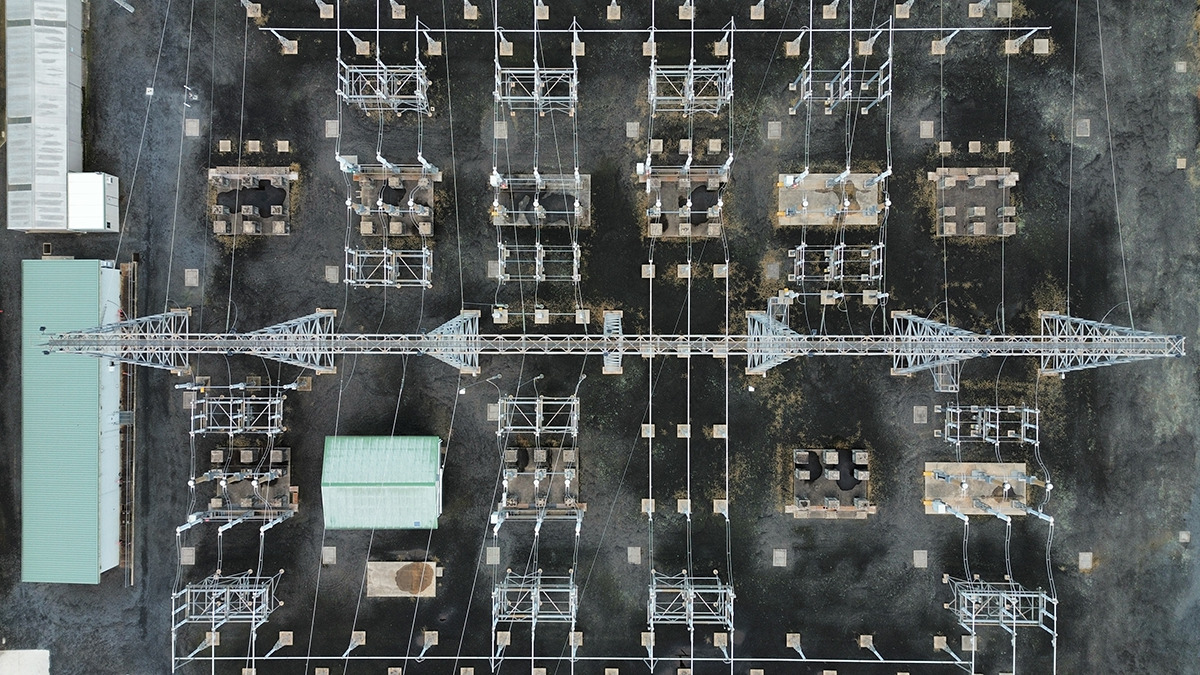 aerial view of electrical substation with wires and towers from top view
