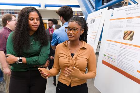 two black engineering students at a poster session at famu-fsu engineering