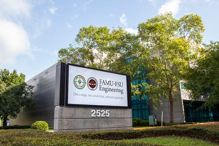 photo of the famu-fsu engineering sign against trees and building and blue sky