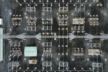 aerial view of electrical substation with wires and towers from top view