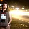 Melanie Munroe stands with her Engineering Senior Design team's human trafficking tracking device prototype
