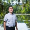 photo of professor ebrahim ahmadisharaf in front of a pond
