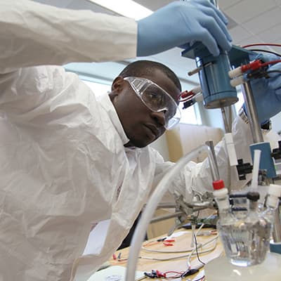 Male student holding lab project