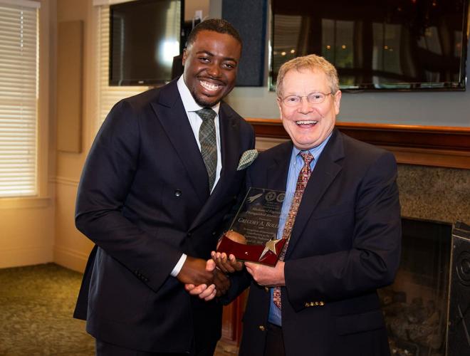 Eric Hellstrom, Ph.D. (right) gives Terrell Finch (left) a Distinguished Alumni Award during the 2019 Department of Mechanical Engineering Alumni Awards Banquet.