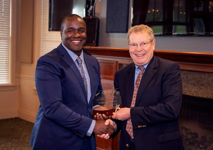 Eric Hellstrom, Ph.D. (right) gives Terrell Finch (left) a Distinguished Alumni Award during the 2019 Department of Mechanical Engineering Alumni Awards Banquet.