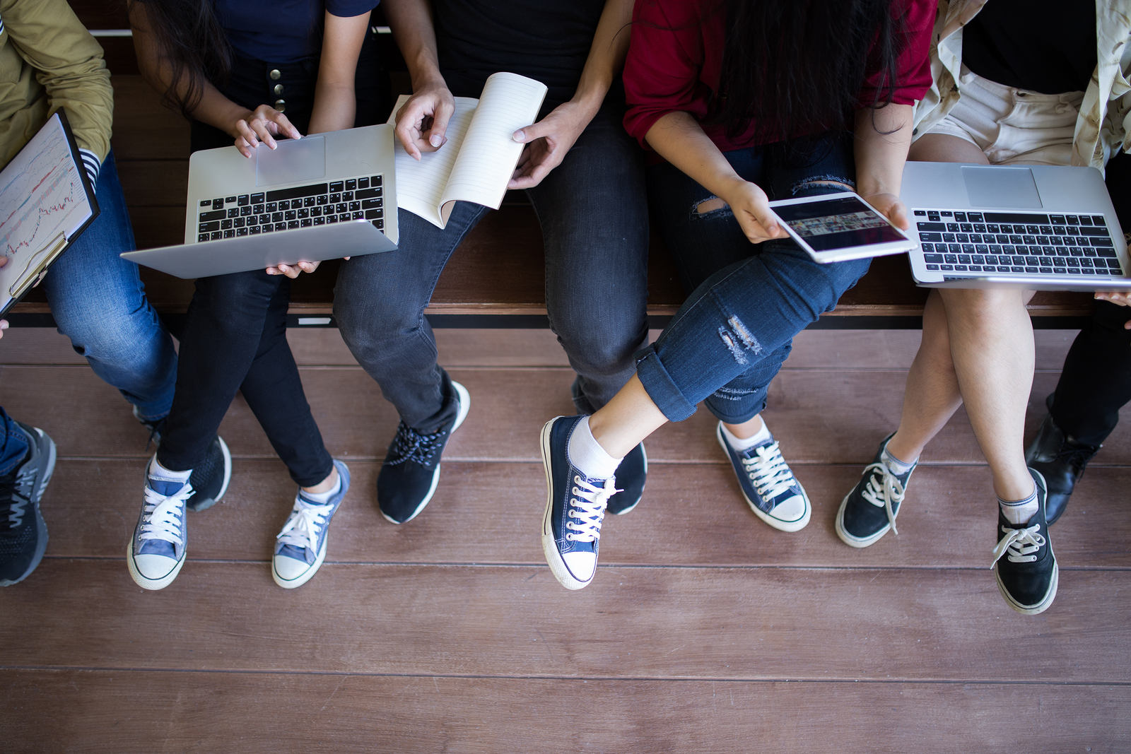 Students sharing laptops-legs
