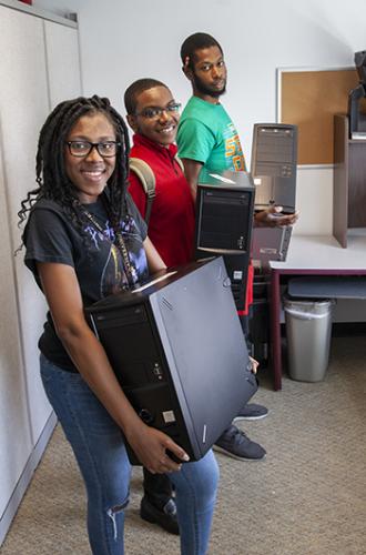 Danica Forestal and NSBE members transporting computers