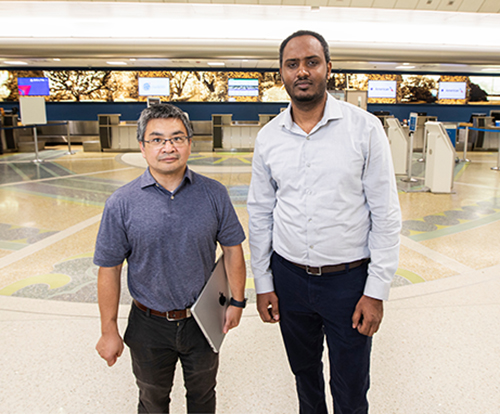 photo of engineering professor hui wang and grad student at airport