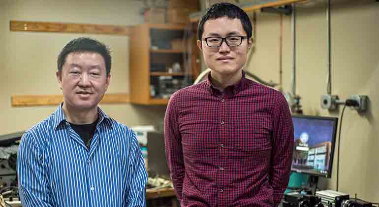 Wei Guo (left) with graduate student Toshiaki Kanai in the cryogenics lab at the National High Magnetic Field Laboratory. Credit: Stephen Bilenky