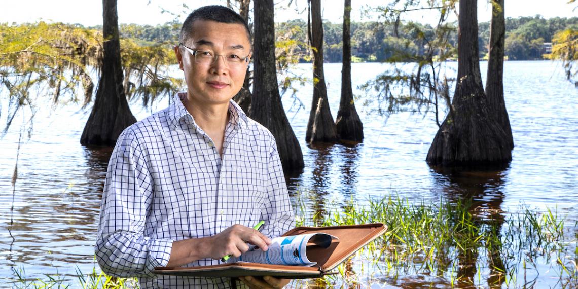 Gang Chen, Ph.D., P.E., photographed by a nearby lake.