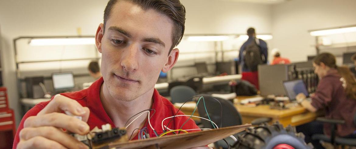 Raymond Klouda works on a robotic car