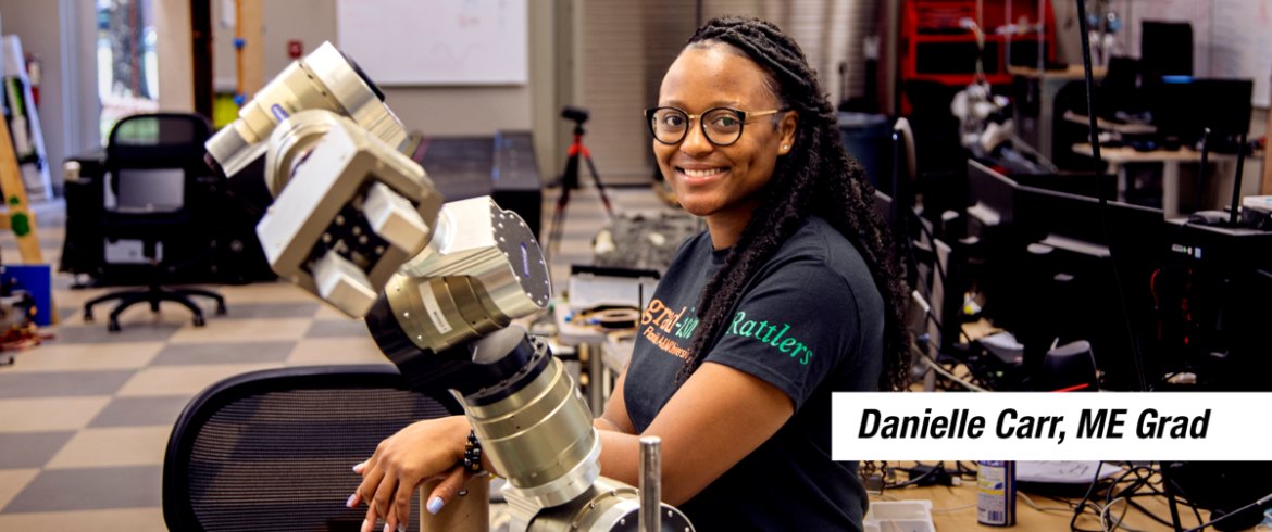 A female engineering graduate student smiling at her accomplishment.