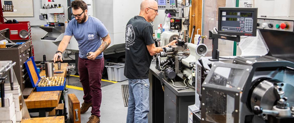 photo of two professional engineering machinists at work in machine shop