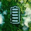 photoillustration of battery icon cut out of forest seen from above