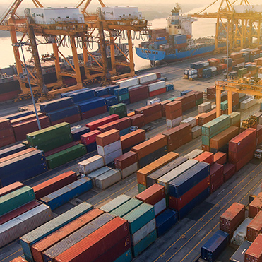Shipping yard full of containers, next to a port