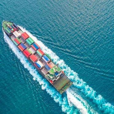 cargo ship moving through the ocean waters
