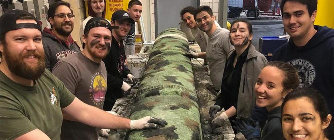 ASCE-FES student members pause for a photo op, while working on a concrete canoe.