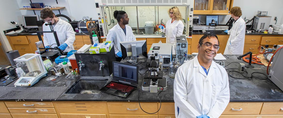 rama with grad students in his lab