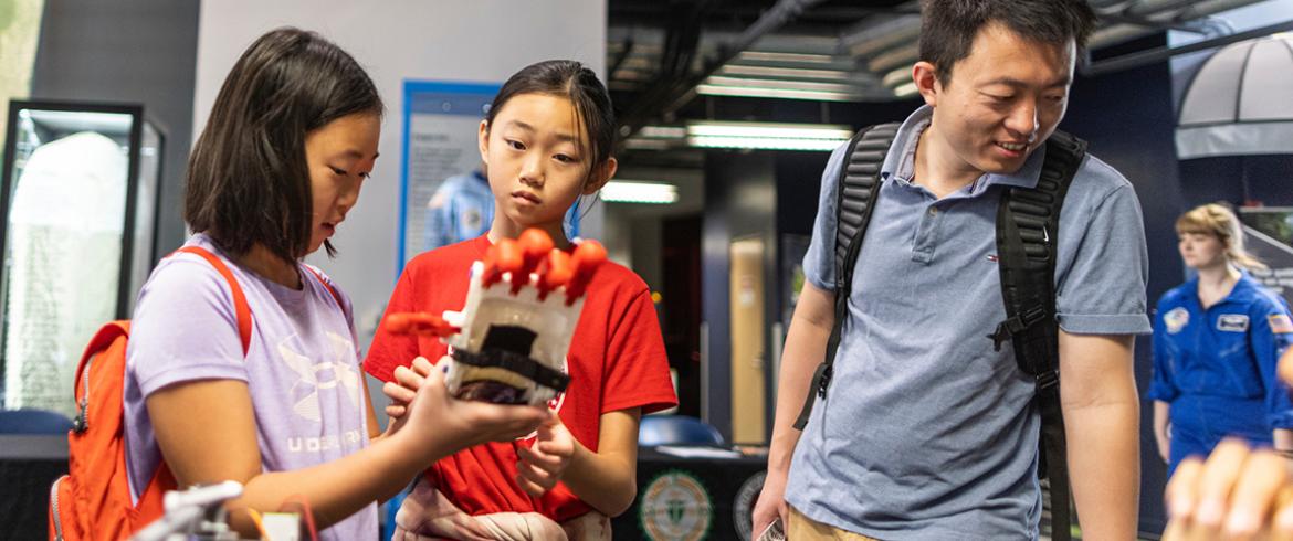 Young visitors enjoy the science experiments during World Engineering Day at the Challenger Learning Center