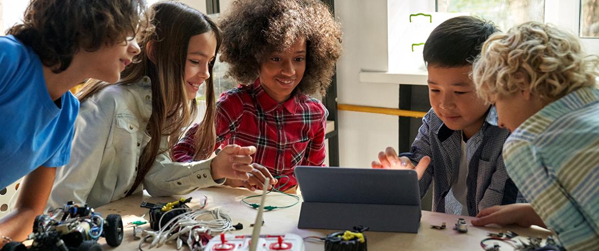 photo of middle school students with robots
