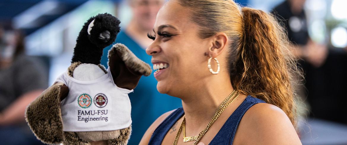 photo of employee holding a plush goose with college of engineering shirt
