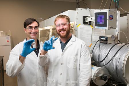 photo of daniel hallinan and michael patric blatt holding test tubes in lab at famu-fsu engineering