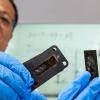 Industrial and Manufacturing engineering research faculty members professors Ayou Hoa, Ph.D and Zhiyong (Richard) Liang, Ph.D. holding pieces of thin heat shields for superfast aircraft.