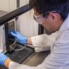 Dr. Gang Chen microwaves some biosolids, separating the organic material from the toxic metals.