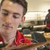 Raymond Klouda works on a robotic car