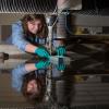 Female student fabricating utilizing 
