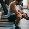man with prosthetic leg sitting on treadmill
