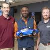 photo of anubi team with scale car in lab