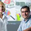 photo of two engineering researchers in front of several images of mold locations in buildings