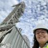 gabrielle mayans in front of large metal crane